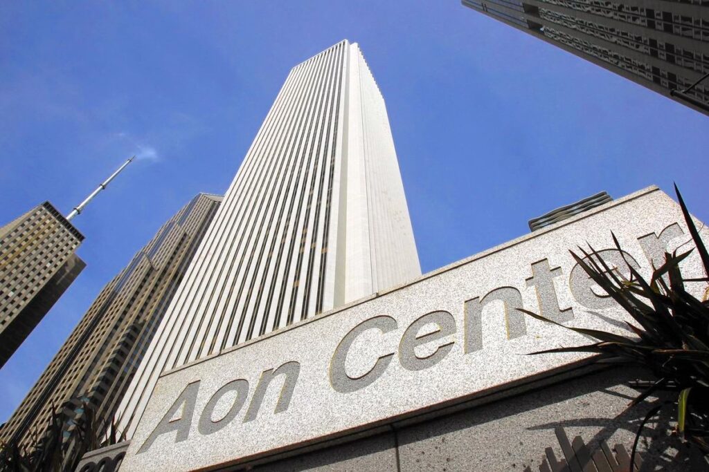 View looking up at Aon Building in Chicago with Aon Center sign in foreground showing White Mount Airy granite